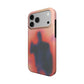 Angled view of the Umbra case showing the soft peach glow and shadow figure wrapping the side